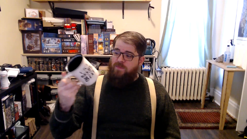 Raymond sitting in his office with a coffee cup in his hand.